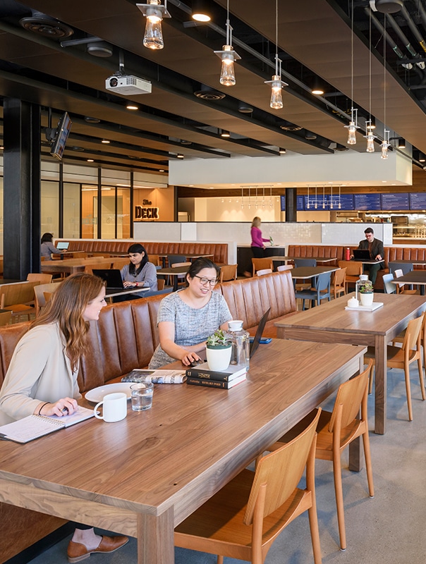 A stunning eatery with long wooden tables and leather booths