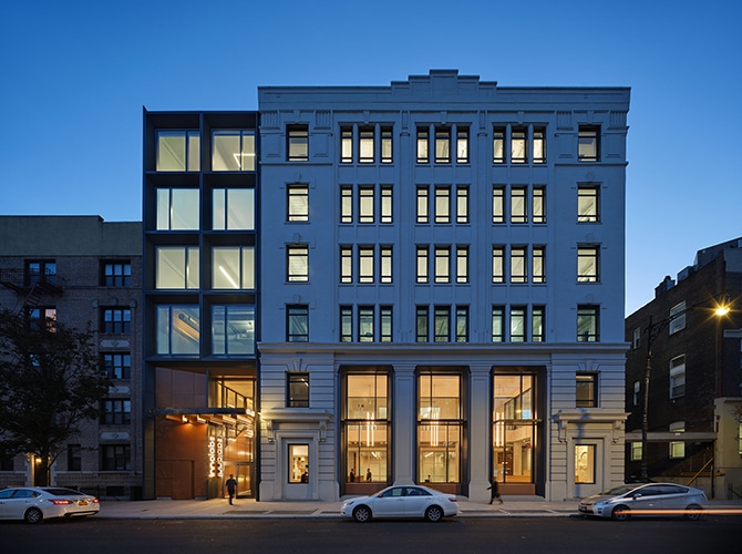 A beautiful office building glowing from the inside during dusk