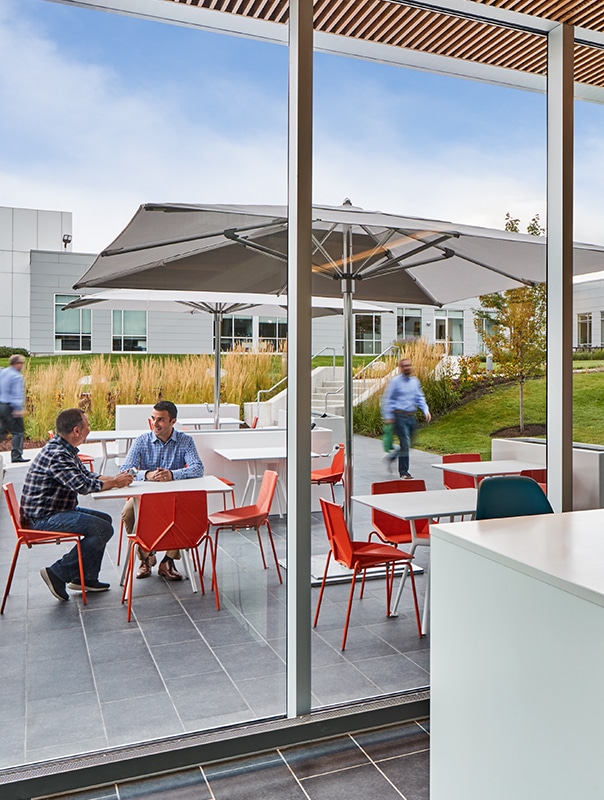 Employees enjoying and outdoor cafe with steel tables and chairs
