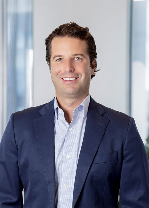 Corporate headshot of Senior Director Xave Jacoby