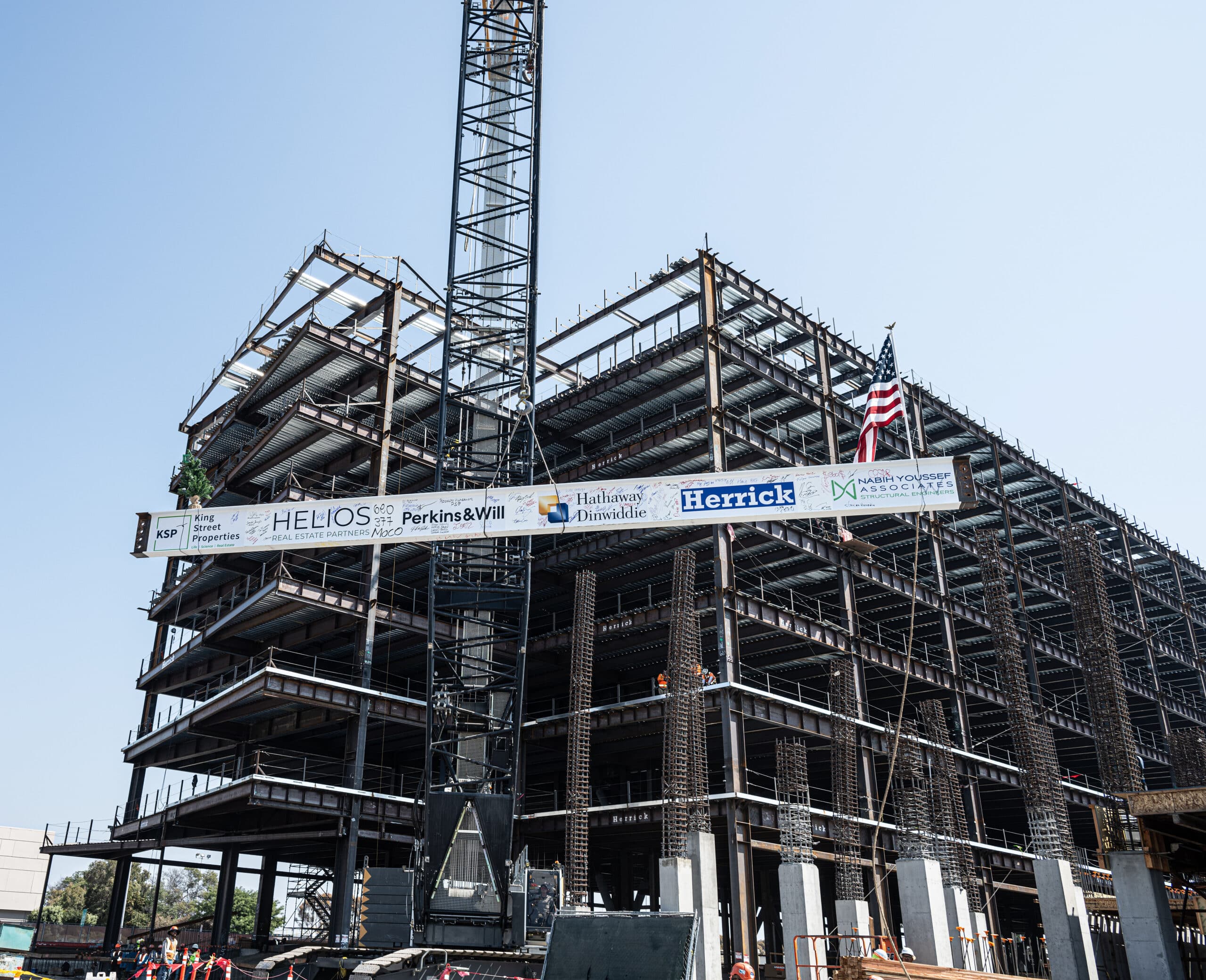 Iron beam with logos being raised